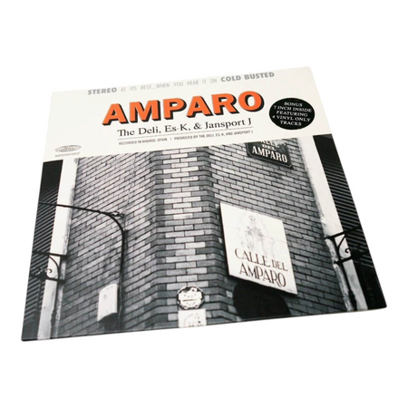 COLD BUSTED Amparo vinyl record cover featuring a black and white street scene in Madrid with orange text accents.