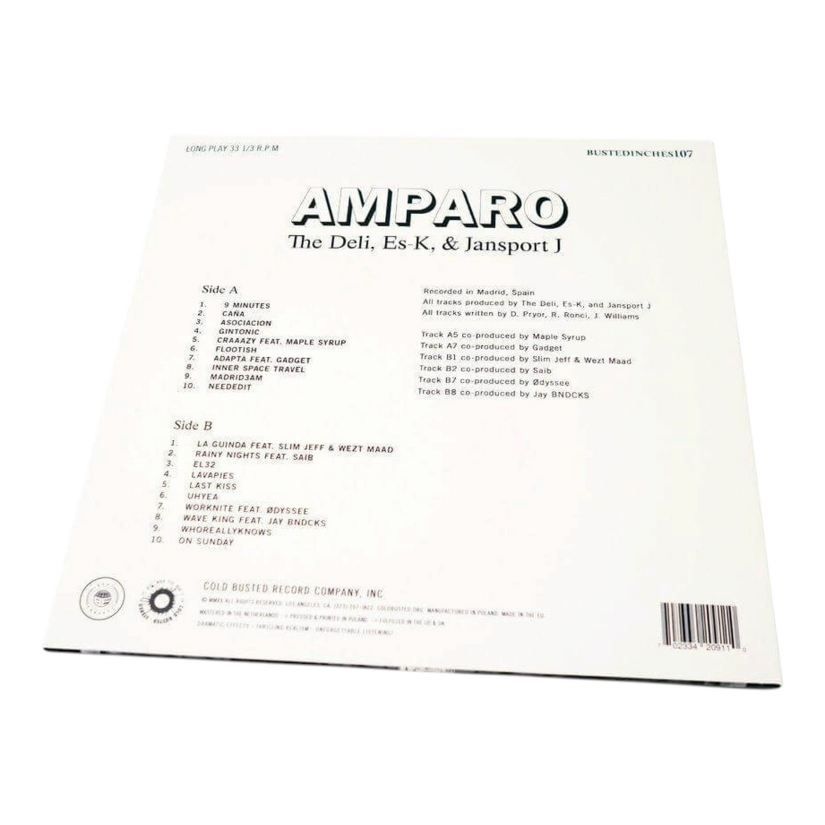 Back cover of COLD BUSTED Amparo vinyl record by The Deli, Es-K, and Jansport J showing the tracklist and credits.
